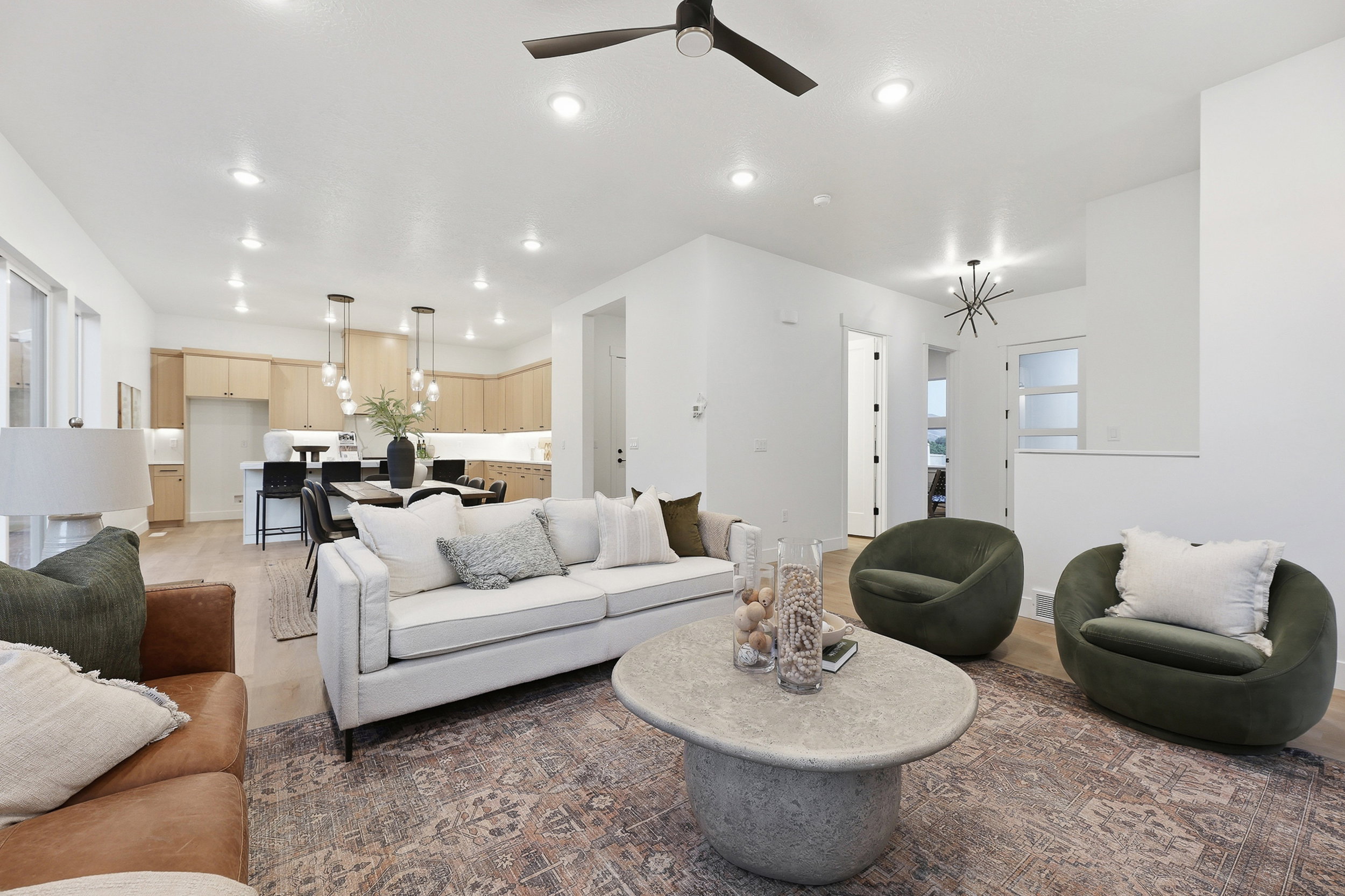 Open-concept living area with light wood-finish flooring throughout