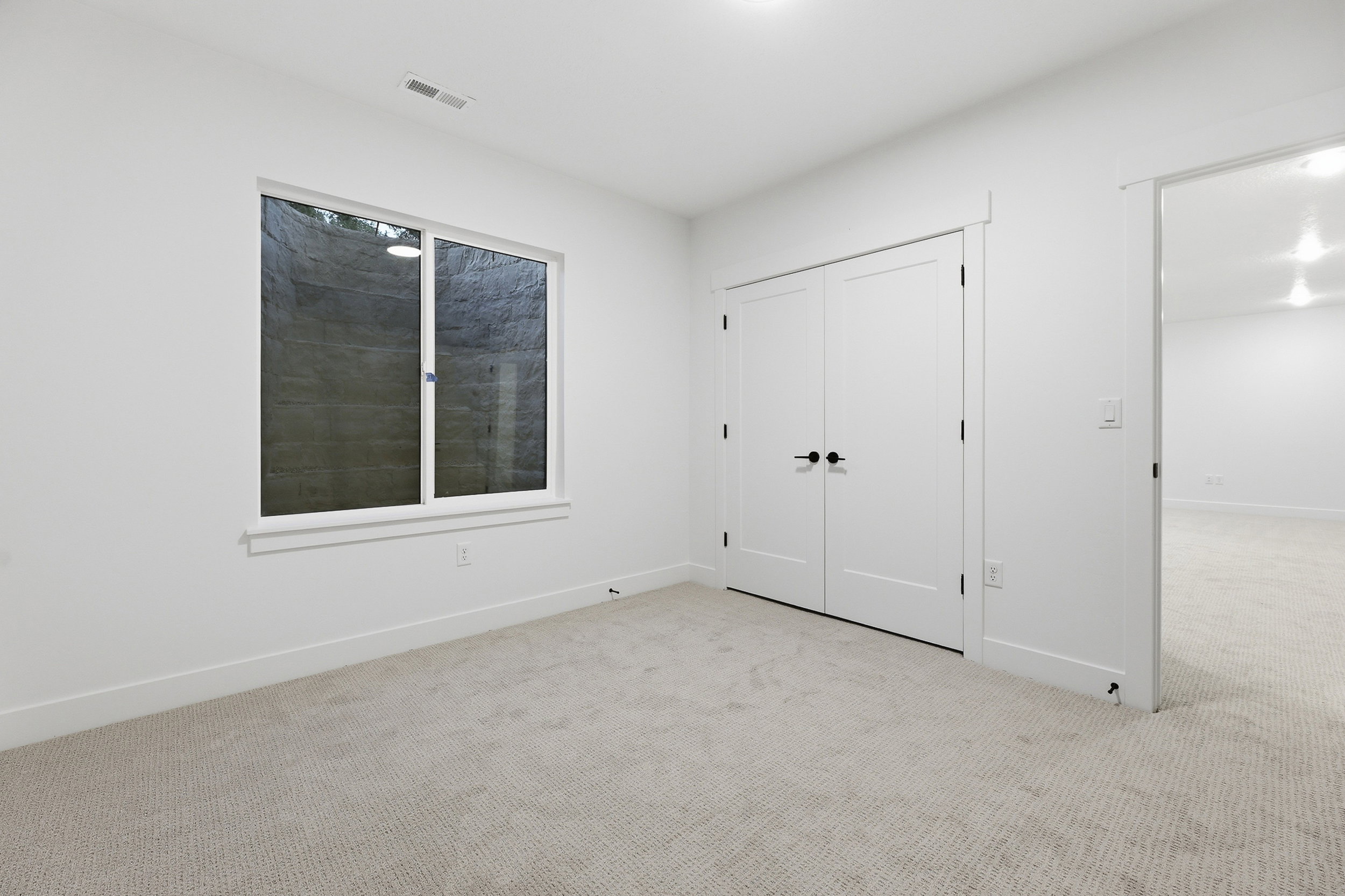 Light neutral-toned carpet throughout, complemented by white walls and trim