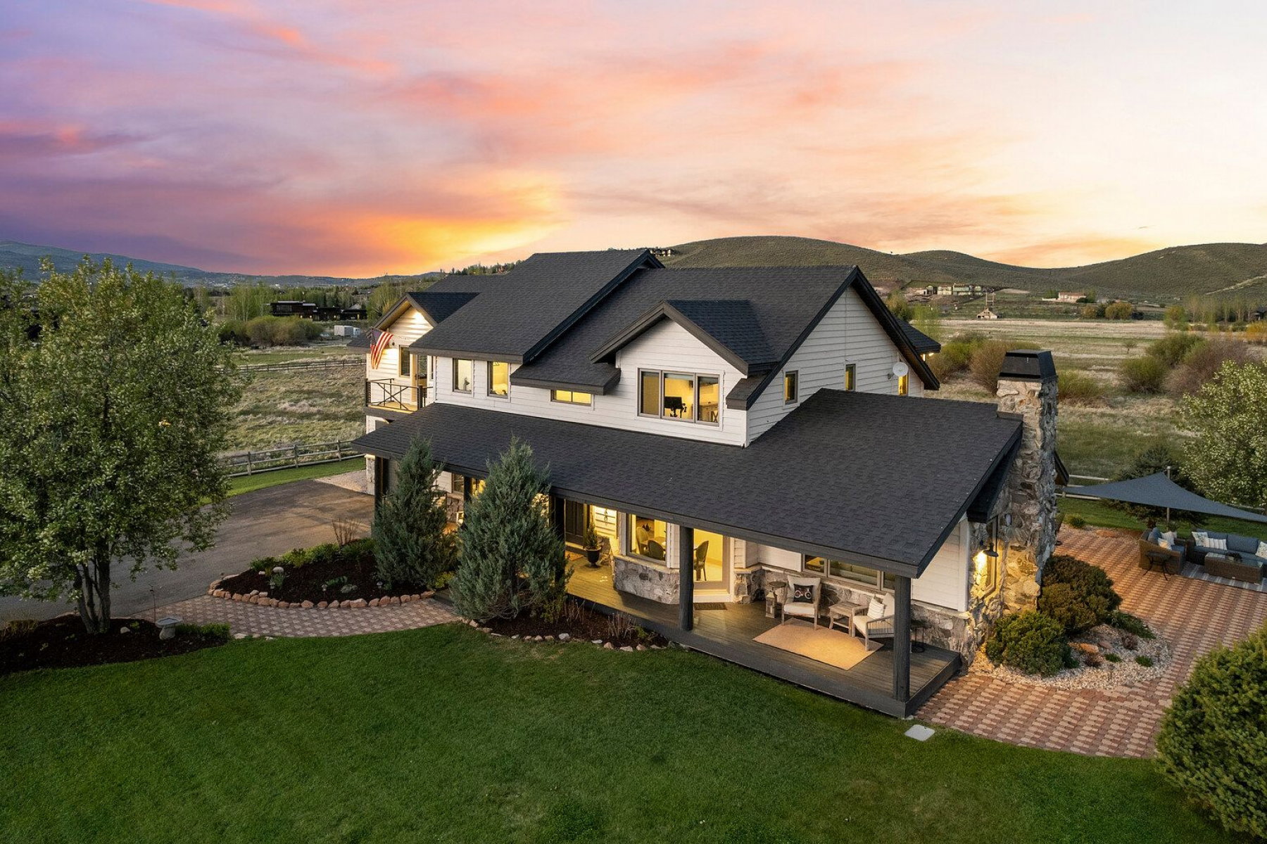Two-story residence featuring white siding and dark roofing