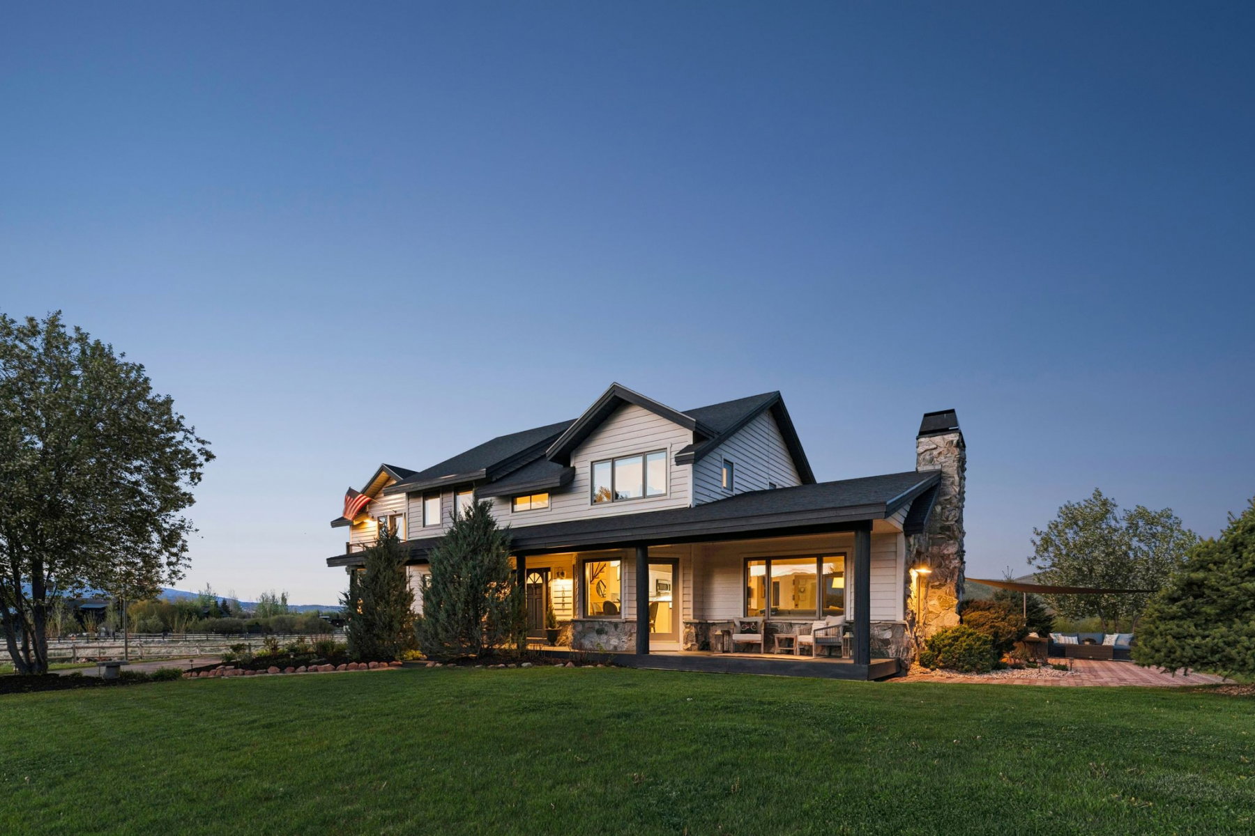 Modern farmhouse exterior with light-toned siding and dark trim
