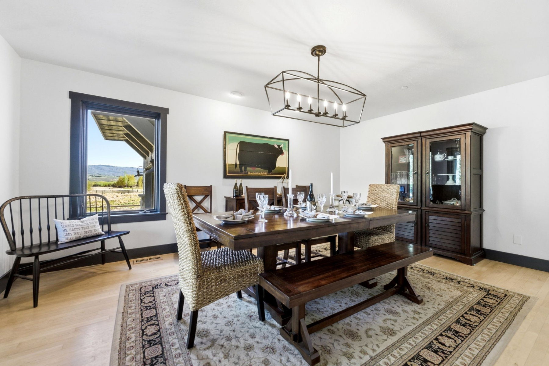 Spacious interior room with light wood-finish flooring and white walls