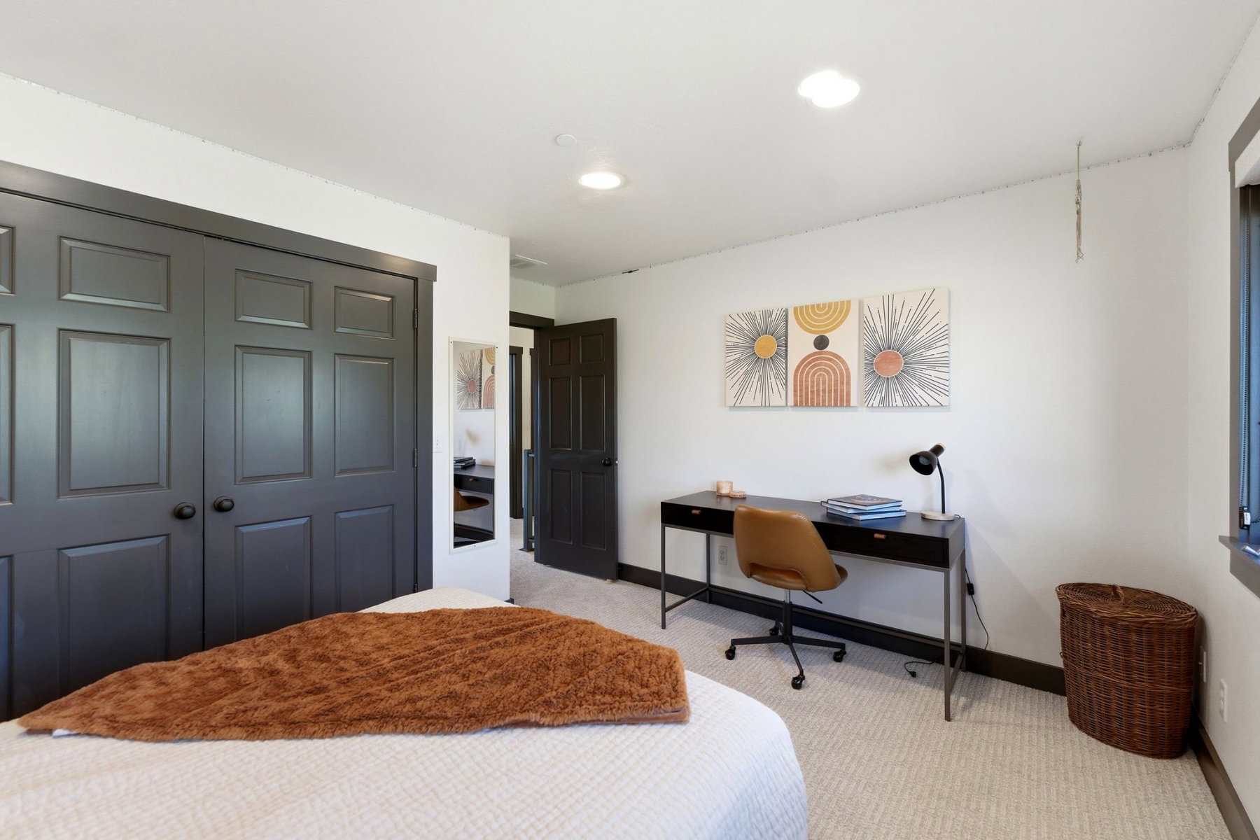 Bedroom featuring white walls with dark trim, recessed lighting, and light-colored carpeting