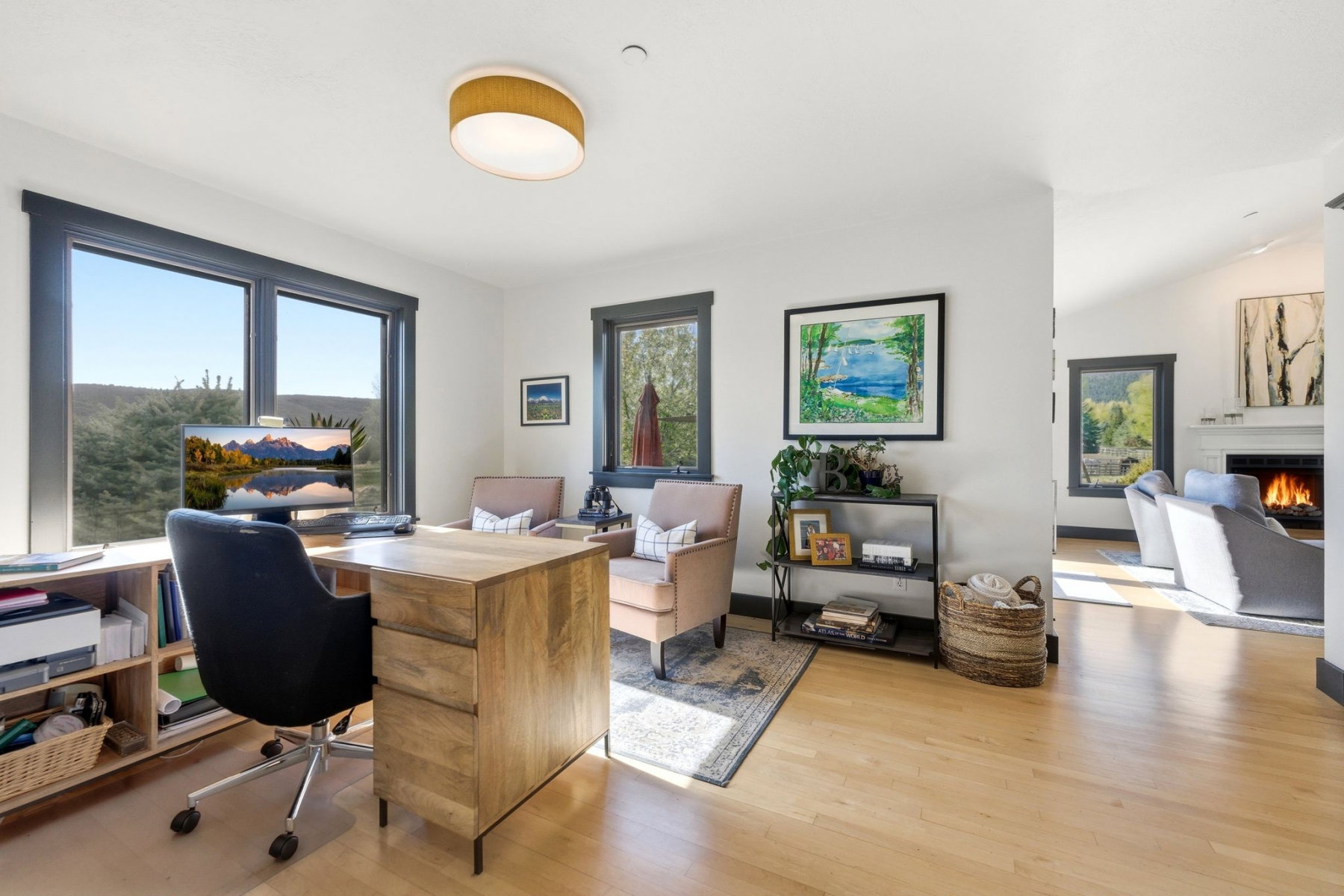 Bright interior space featuring light wood-finish flooring and ample natural light from multiple windows