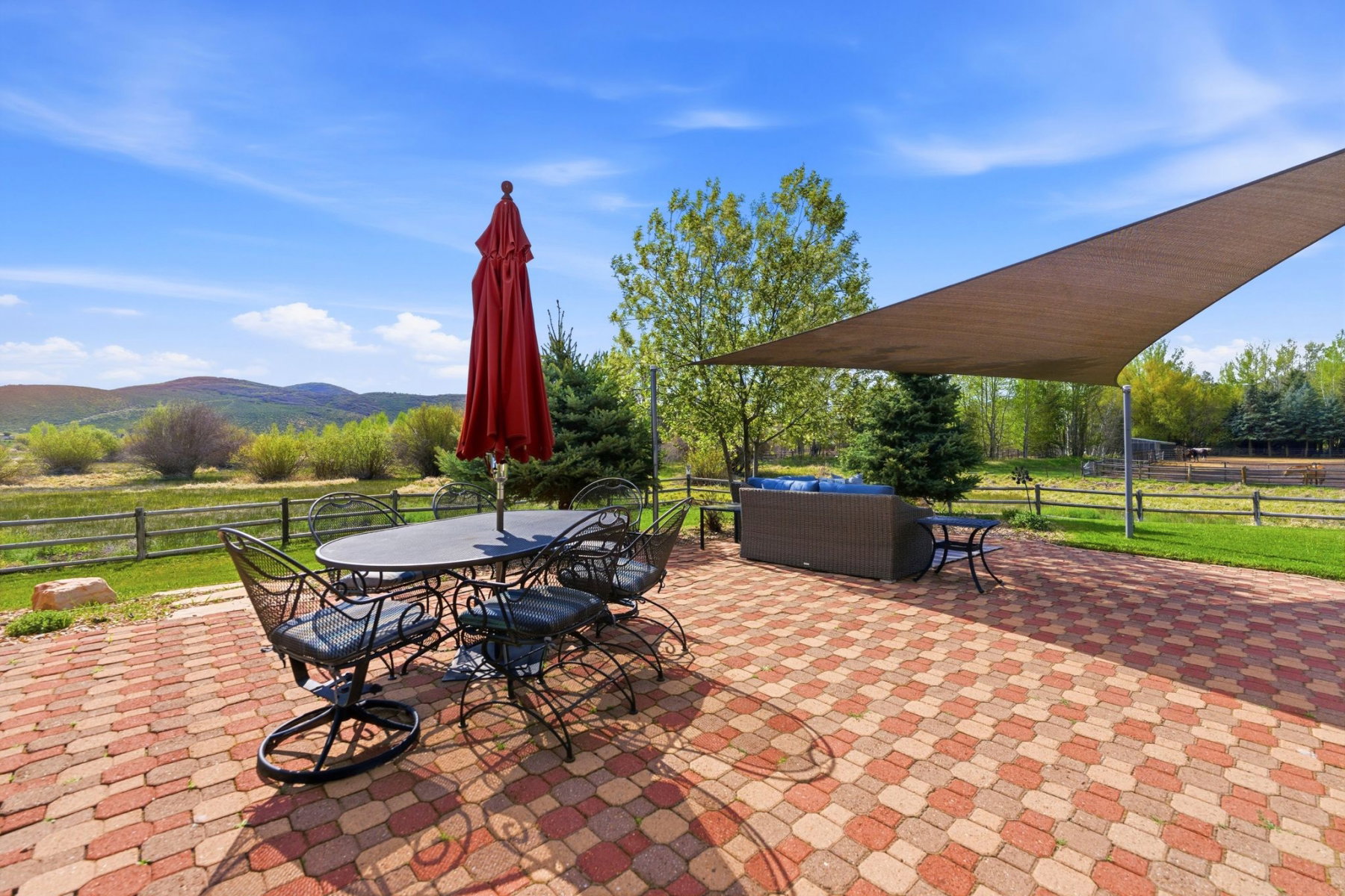 Expansive paver patio with a multi-toned brick pattern, offering significant outdoor space