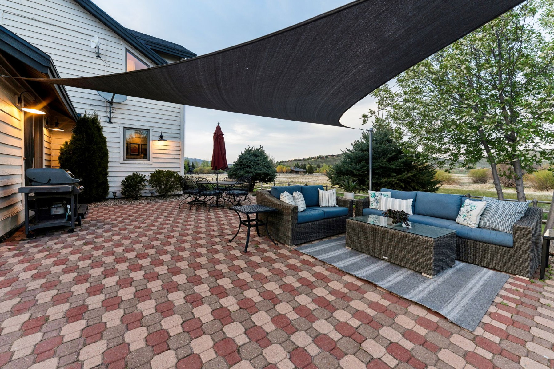 Expansive outdoor patio featuring a red and tan paver design