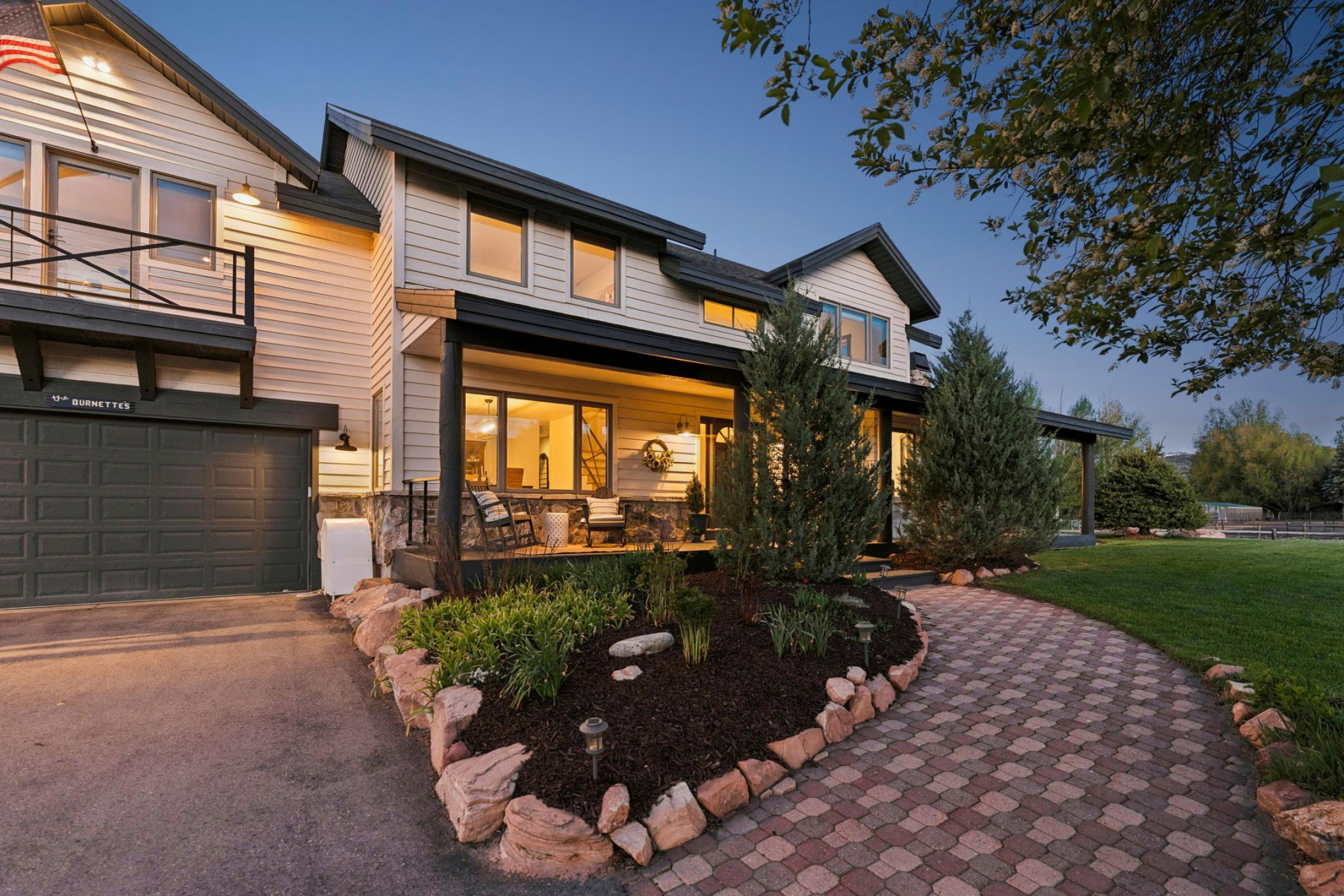 Contemporary home exterior featuring light-colored siding and dark trim accents