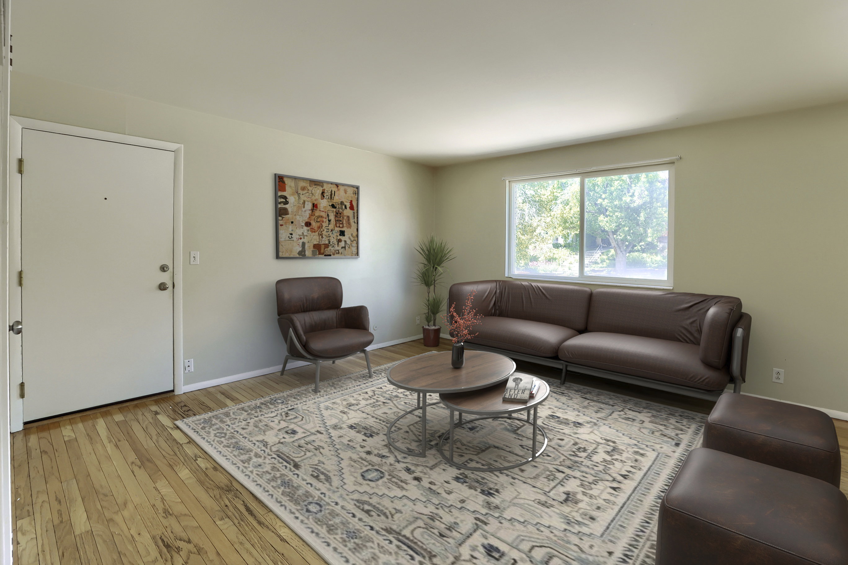 Light-toned walls complement wood-finish flooring throughout this living space