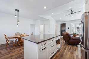 Custom built ADU/Kitchen island with white cabinetry and dark countertop