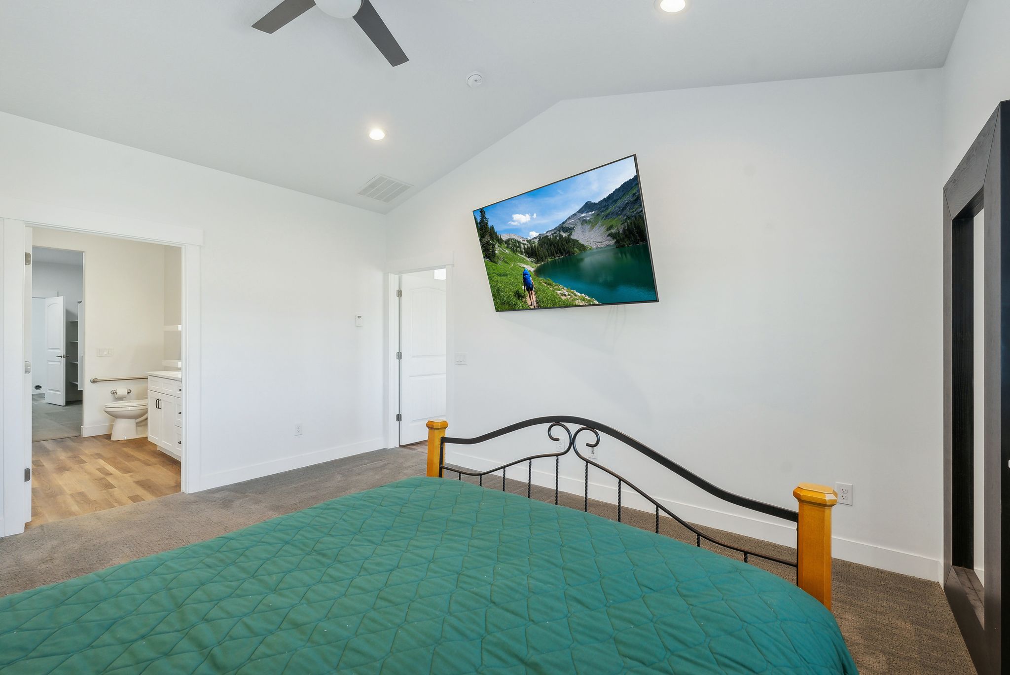 Custom built ADU/Bedroom with vaulted ceiling, recessed lighting, and a contemporary ceiling fan