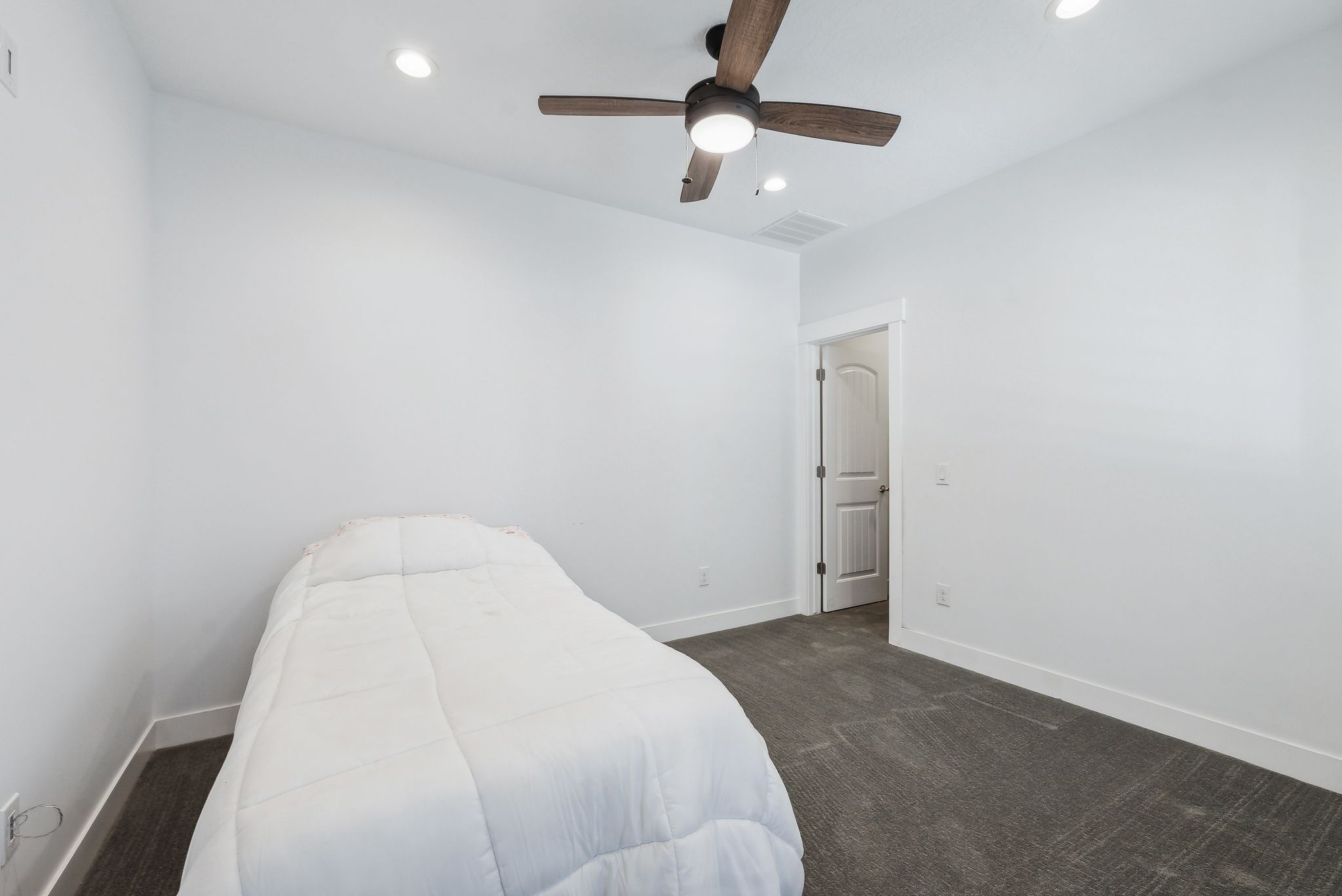 Custom built ADU/Bedroom featuring a ceiling fan with integrated lighting, recessed lighting, white trim, and dark gray carpet flooring
