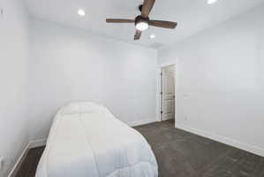 Custom built ADU/Bedroom featuring a ceiling fan with integrated lighting, recessed lighting, white trim, and dark gray carpet flooring