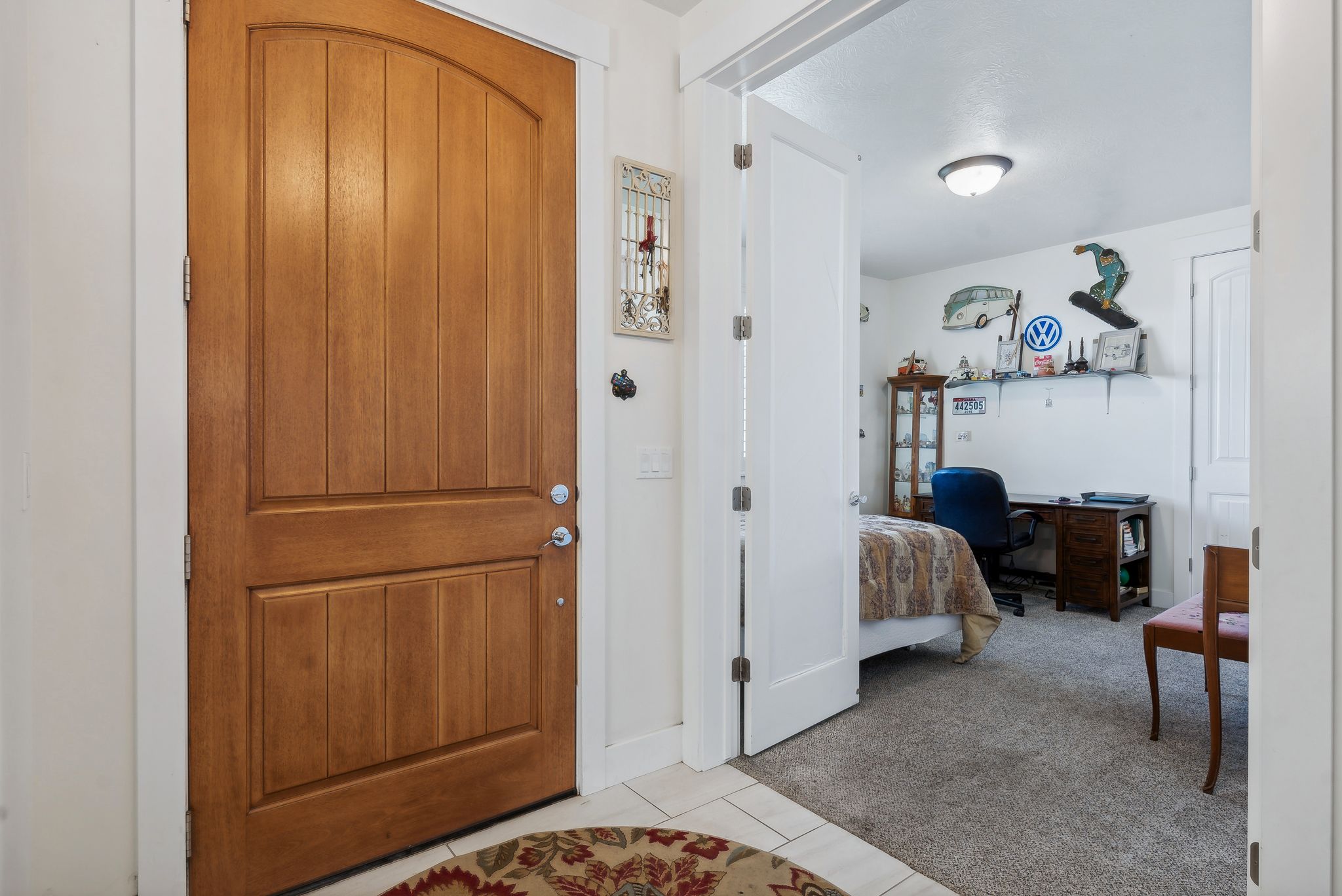 Entryway featuring a natural wood-finish door with an arched top panel