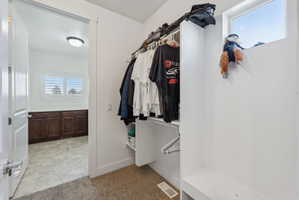 Walk-in closet with built-in shelving and hanging rods