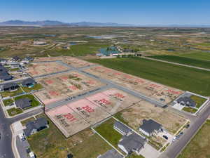 Expansive aerial view showcasing a developing residential area with multiple available lots