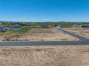 Newly paved road infrastructure with surrounding undeveloped land