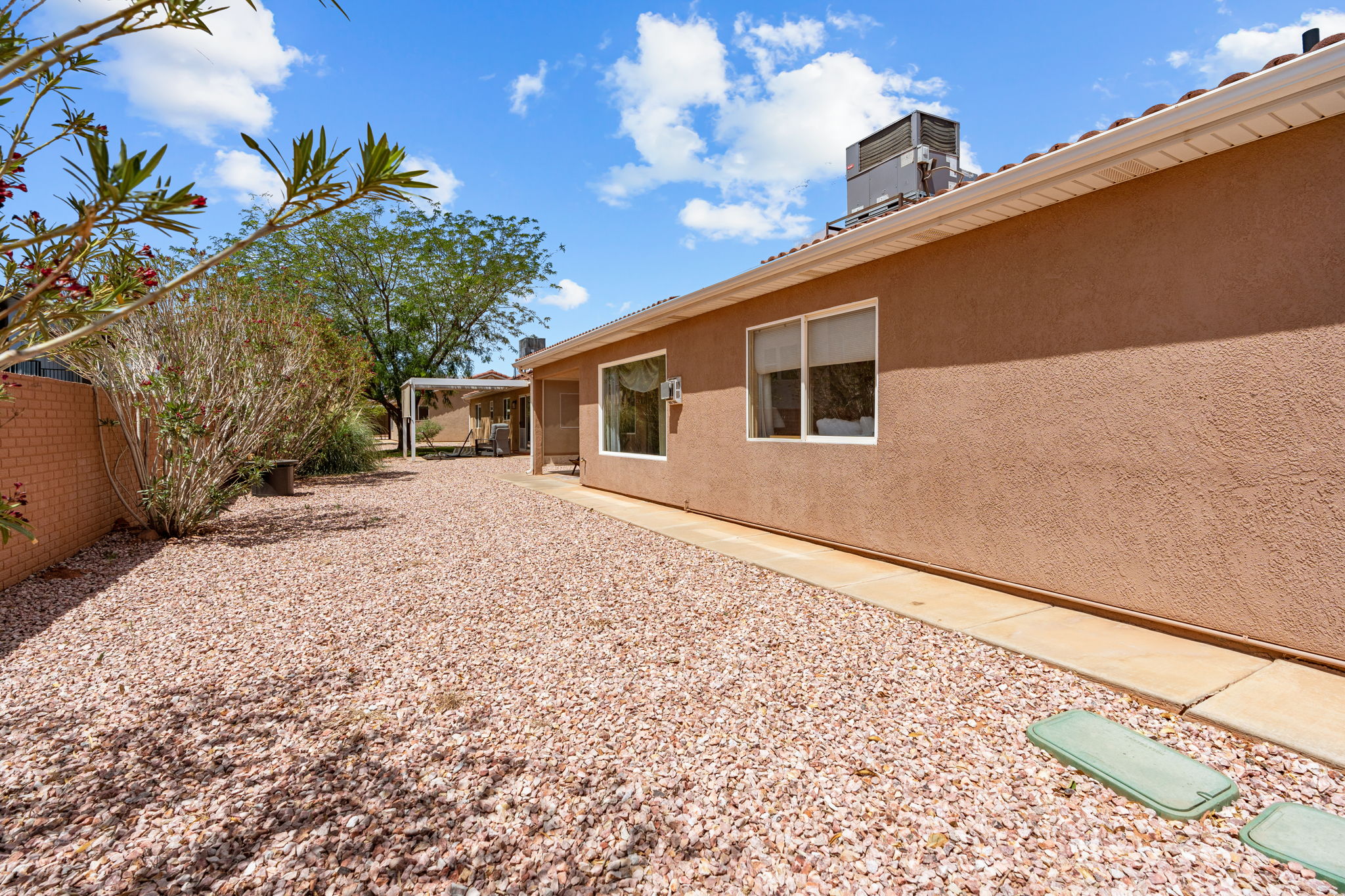 Xeriscape landscaping featuring gravel ground cover and mature shrubbery