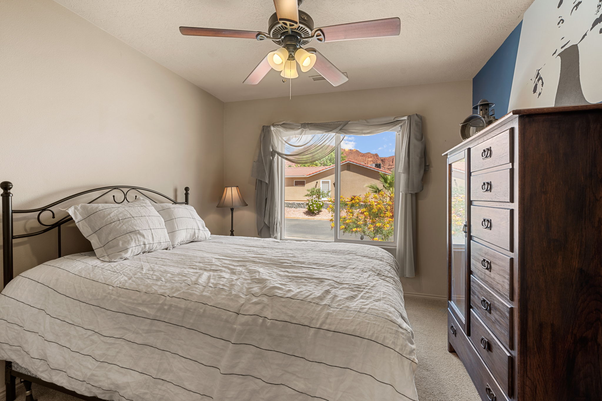 Room featuring neutral wall tones, a ceiling fan with integrated lighting, and carpet flooring