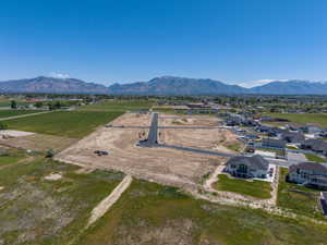 Expansive undeveloped land parcels with newly paved roads, surrounded by green fields