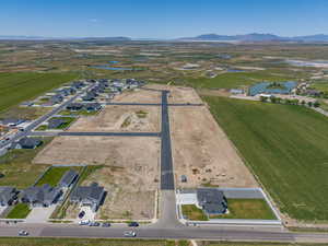 Expansive land parcel featuring developed roads, existing infrastructure, and new construction homes