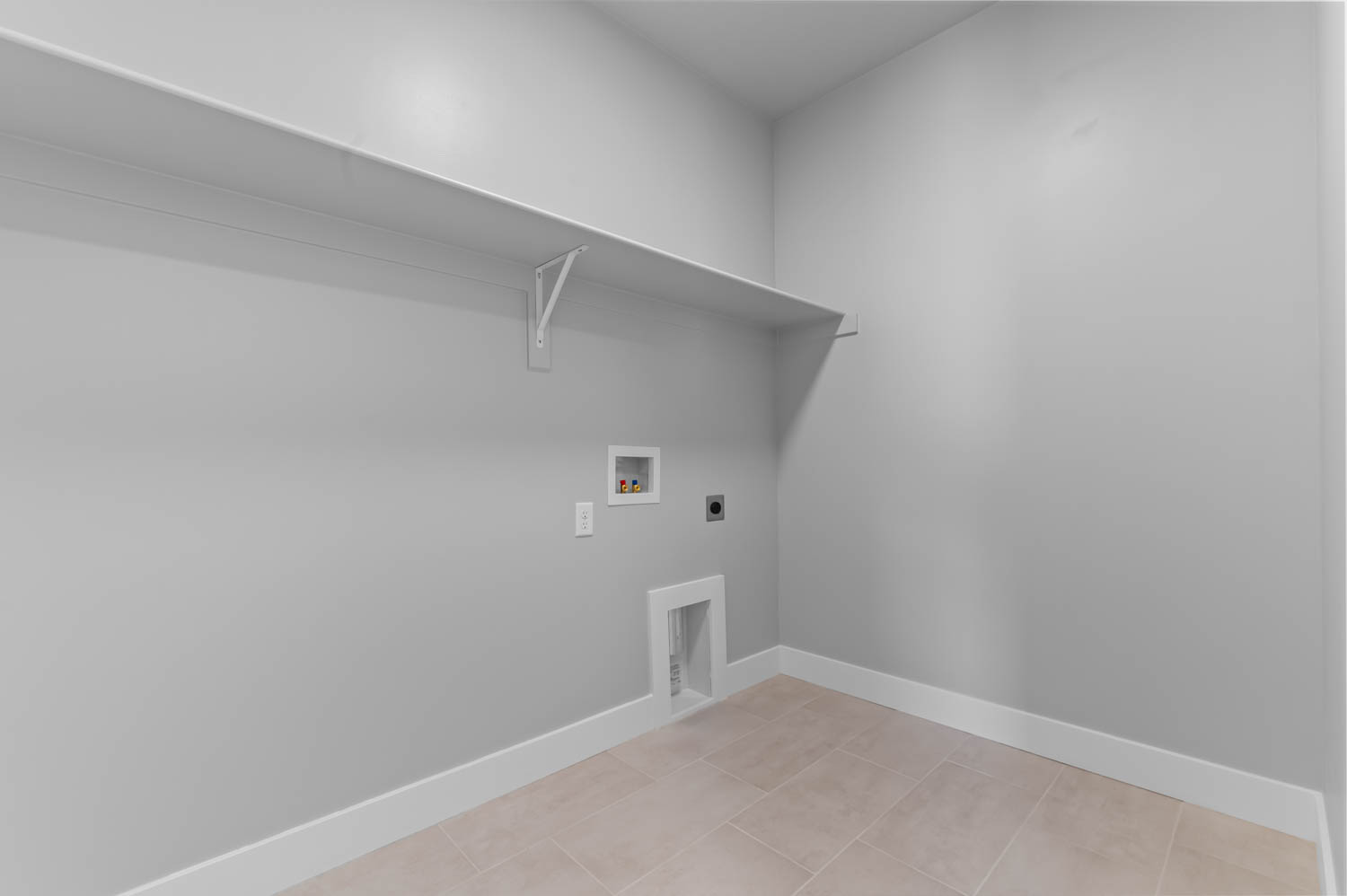 Laundry area with light-toned wall paint and white trim