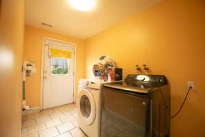 Utility room featuring tile flooring, a white exterior door with a window, and overhead lighting