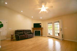 Vaulted ceiling with recessed lighting and a ceiling fan