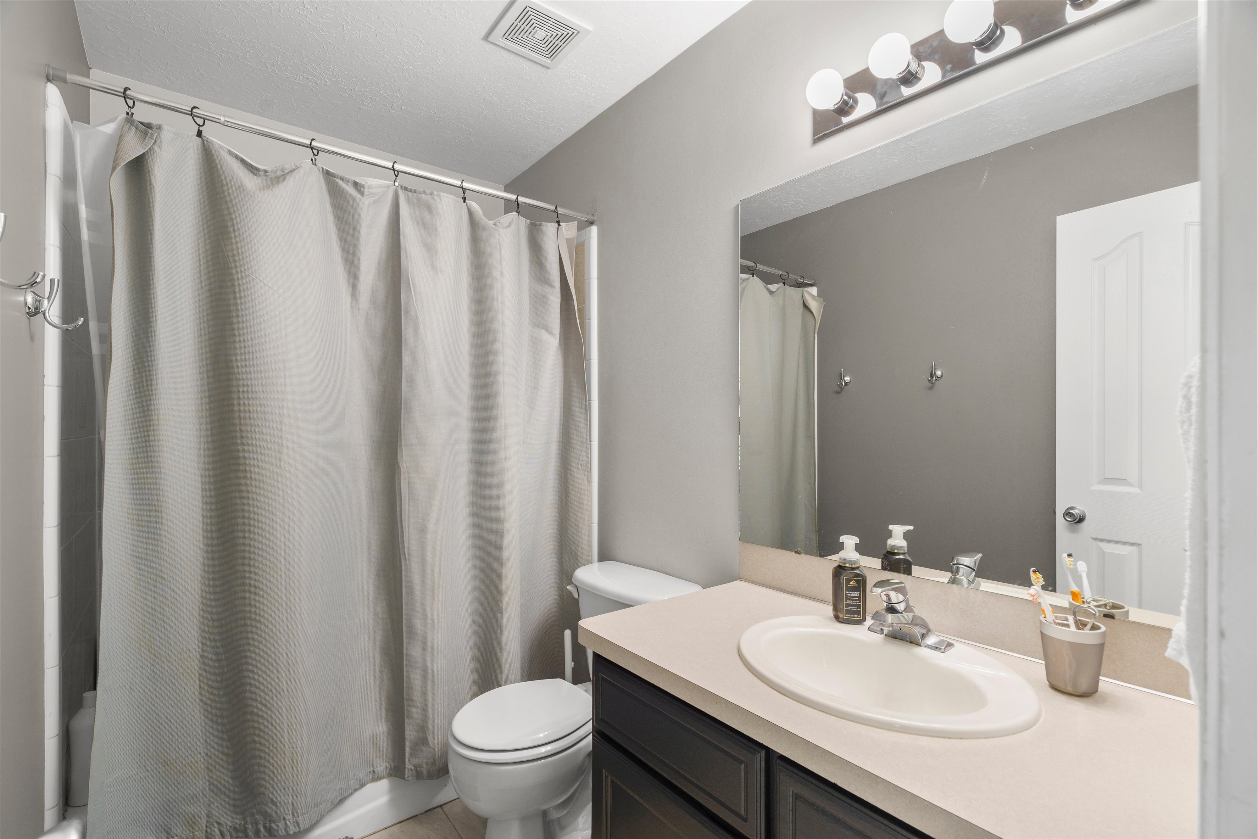 Full bathroom with tile flooring
