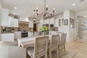 Bright kitchen featuring white cabinetry, light countertops, and a tile backsplash