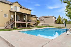 In-ground swimming pool featuring a concrete surround