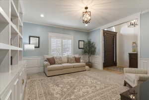 Light-filled interior space featuring custom built-in shelving, elegant wainscoting, plantation shutters, and a dark wood entry door with sidelights