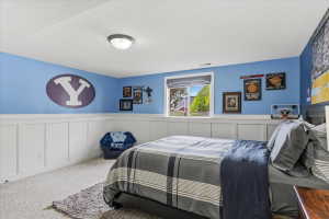 Room featuring wainscoting and light blue painted walls