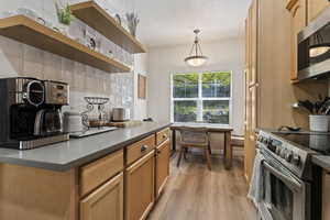Integrated dining area with window overlooking exterior landscaping