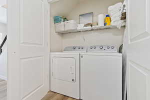 Dedicated laundry closet with wood-finish flooring