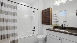 Contemporary bathroom featuring a white vanity with dark countertop, large mirror, and black matte fixtures