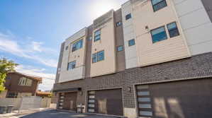 Modern multi-level townhome exterior featuring contemporary design elements