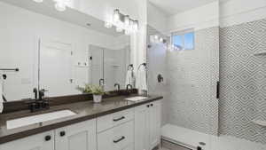 Dual vanity with a dark countertop and undermount sinks, featuring matte black fixtures and hardware