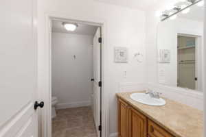 Bathroom featuring a single vanity with wood cabinetry and a neutral countertop