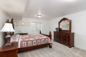 Carpeted room featuring a white ceiling and walls