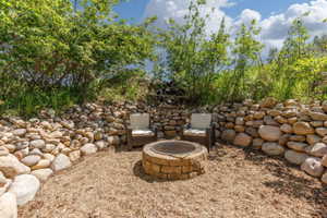 Outdoor gathering area featuring a stone-built fire pit