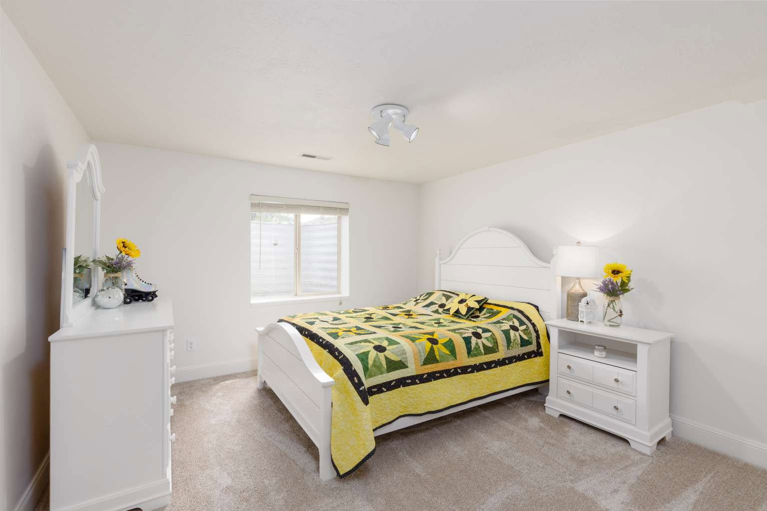 Bedroom featuring white walls, light-colored carpeting, and a window with horizontal blinds