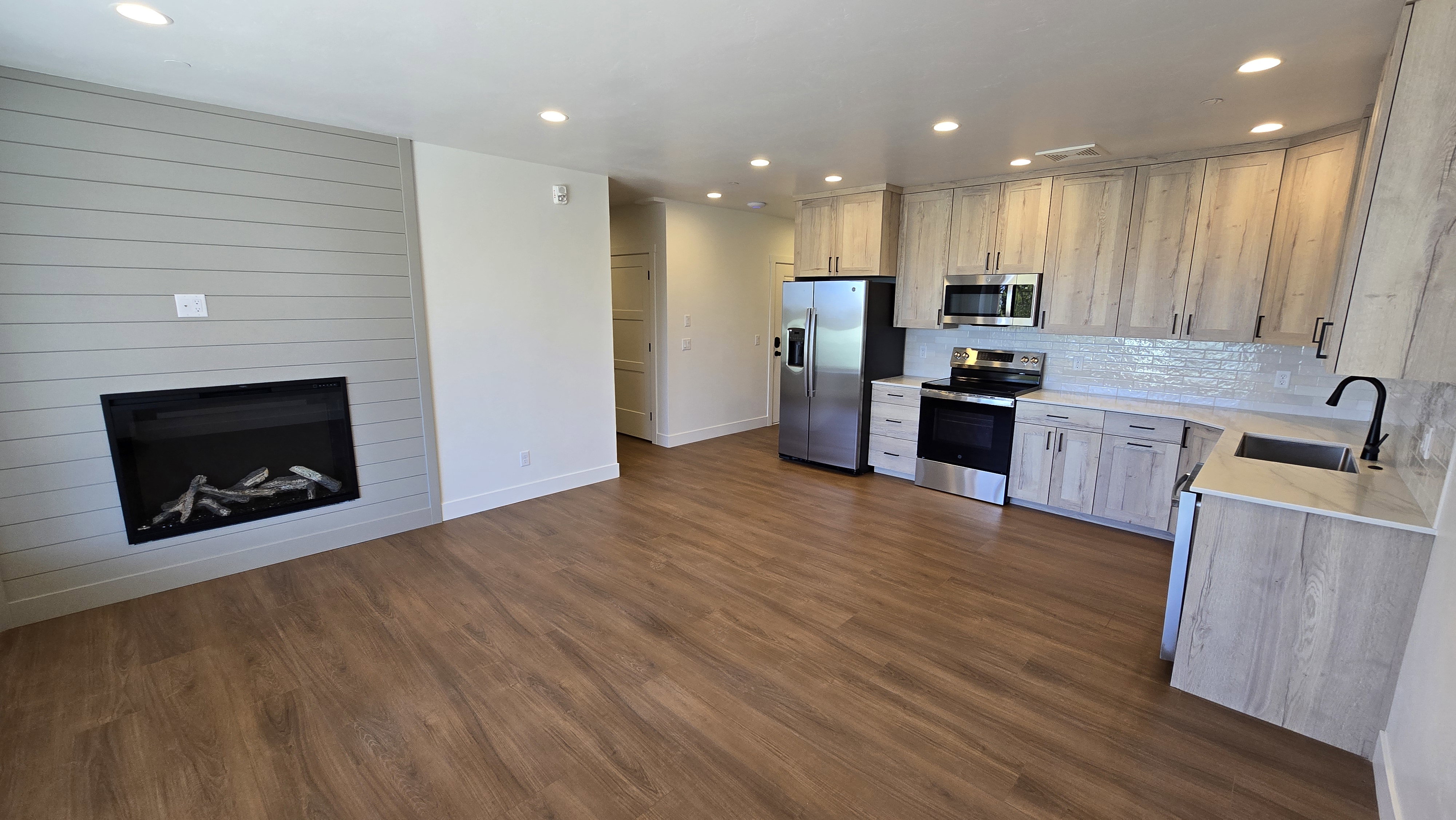 Open-concept living space featuring wood-finish flooring