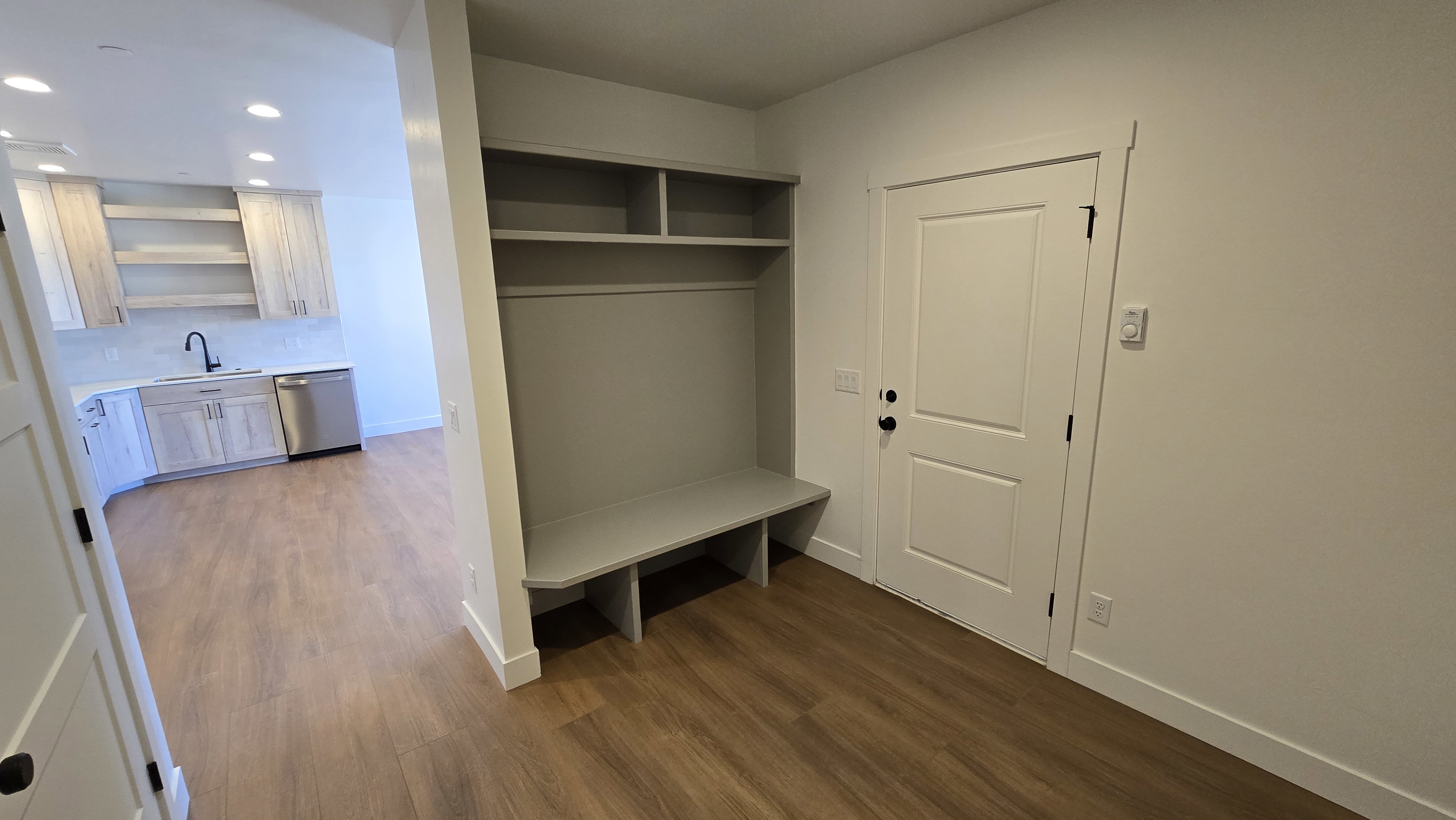 Entryway mudroom with built-in shelving and bench seating
