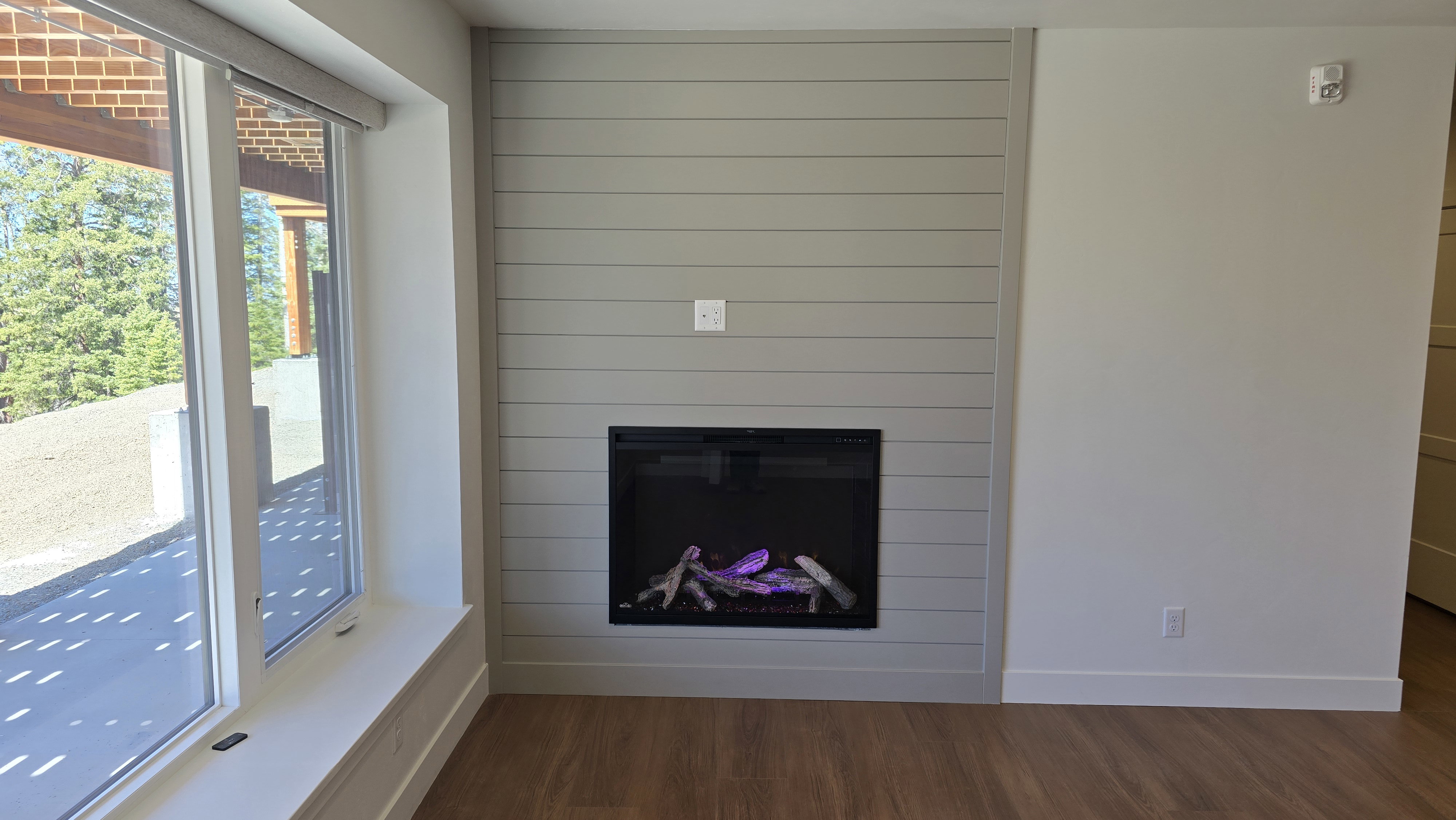 Shiplap accent wall featuring a built-in fireplace