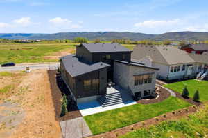 Modern architectural design featuring a multi-level structure with a dark-toned exterior