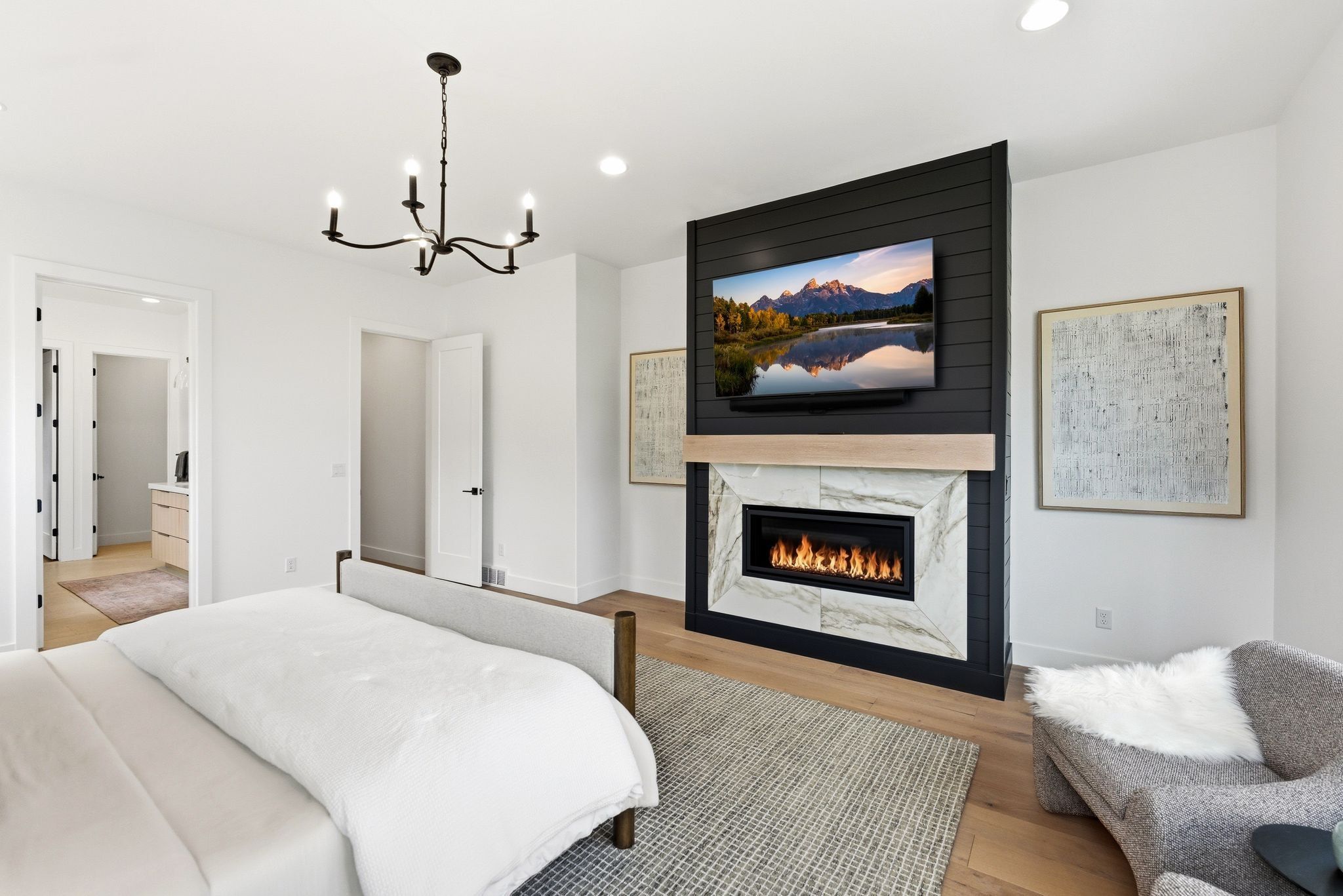 Accent wall with a linear fireplace featuring a stone surround and a light wood-finish mantel