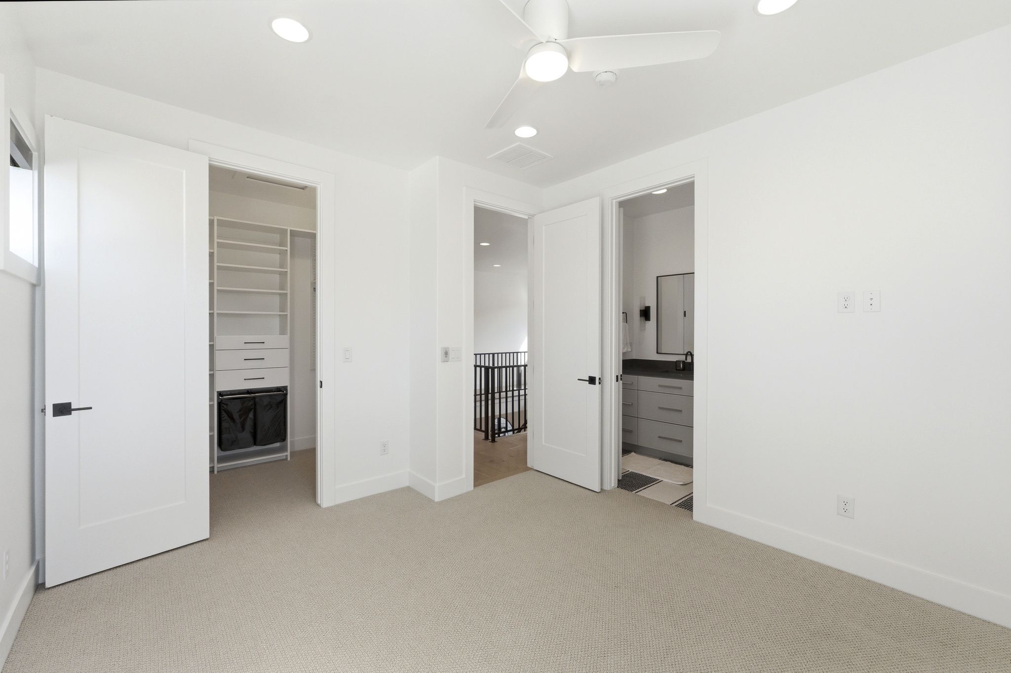Carpeted room featuring a ceiling fan, recessed lighting, and a window