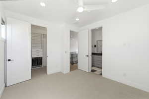 Carpeted room featuring a ceiling fan, recessed lighting, and a window