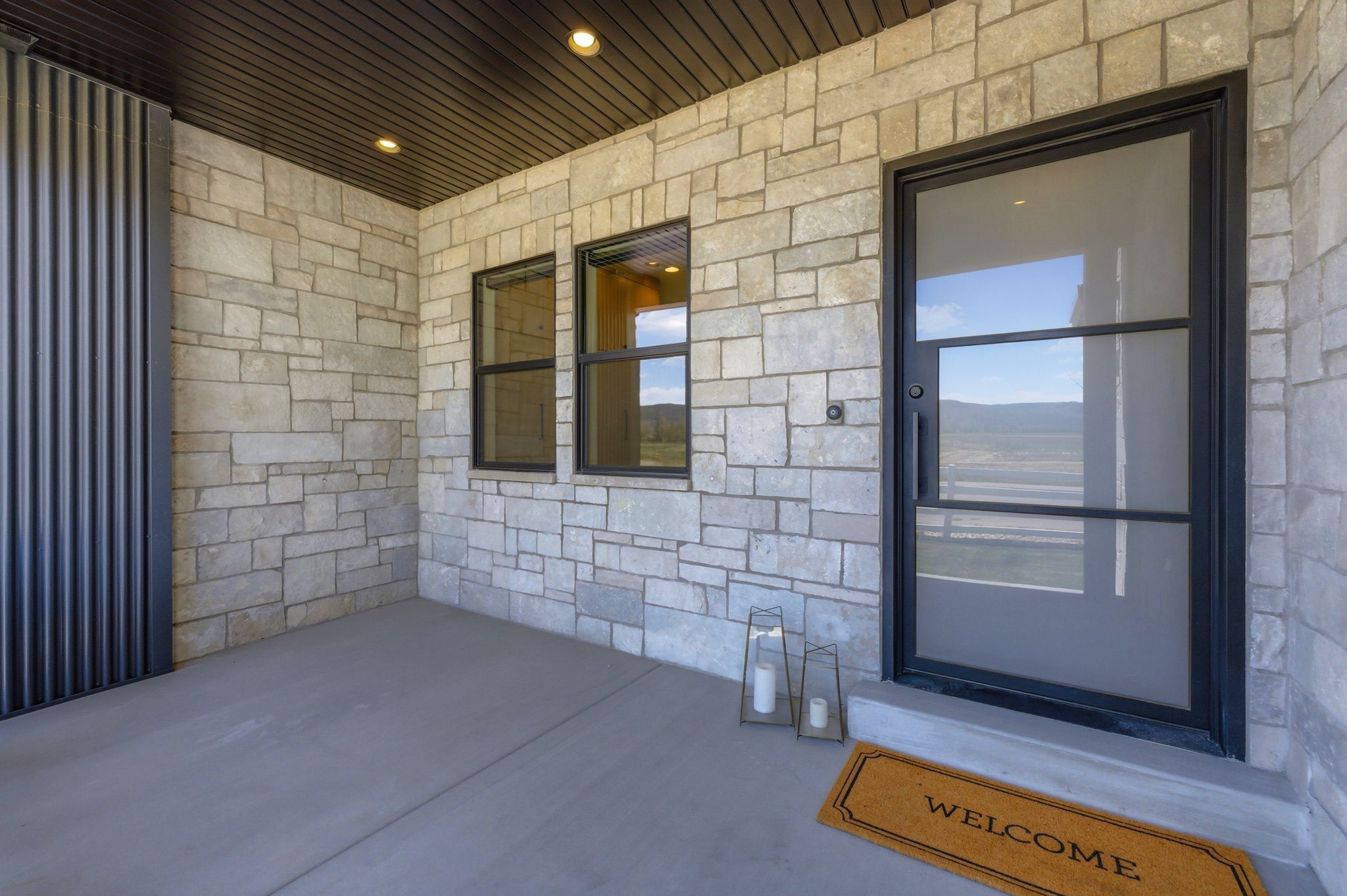 Stone veneer exterior with a corrugated metal accent panel