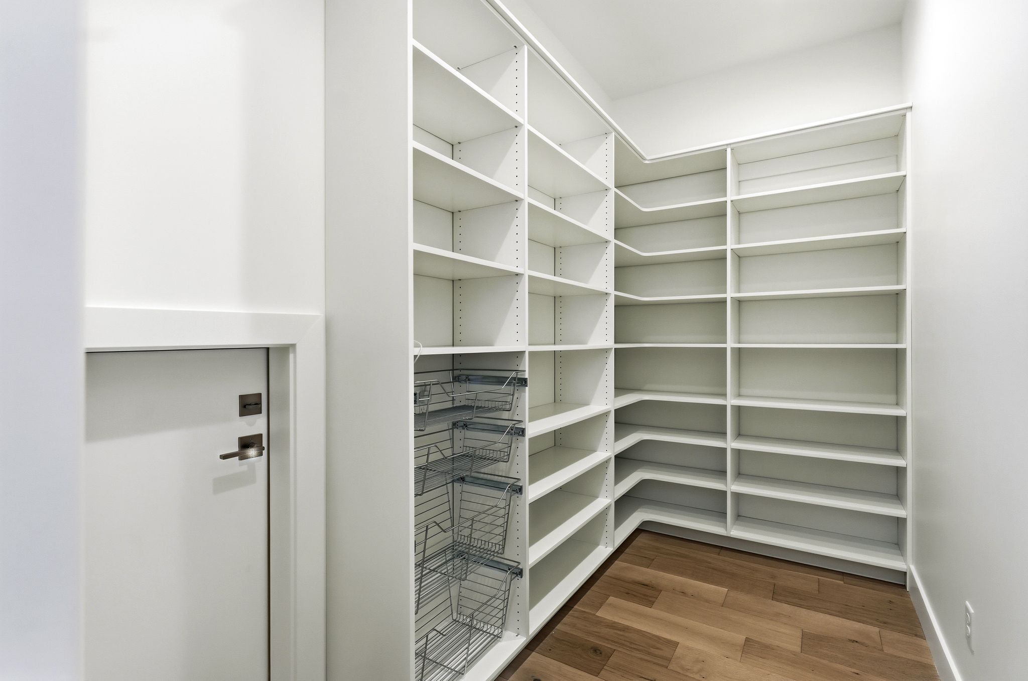 Custom-designed pantry featuring extensive white shelving