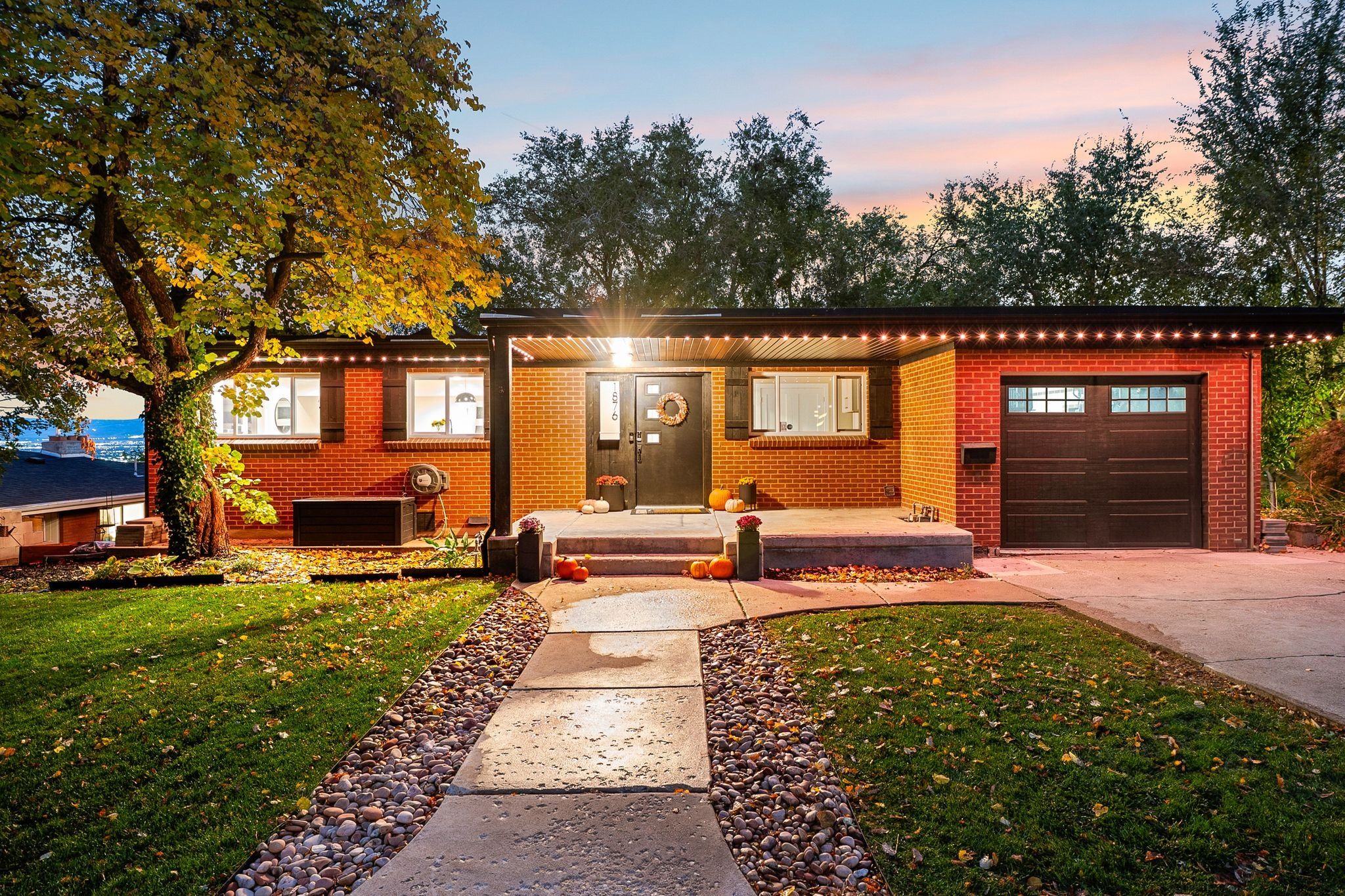 Brick residence featuring a covered front entry with an overhead light fixture